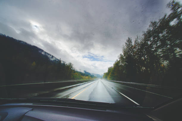 Passenger point of view from car highway through the forest in the rain towards Portland Oregon USA