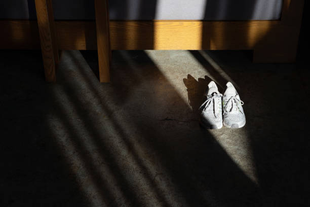 White running shoes on concrete floor in dark room stock photo