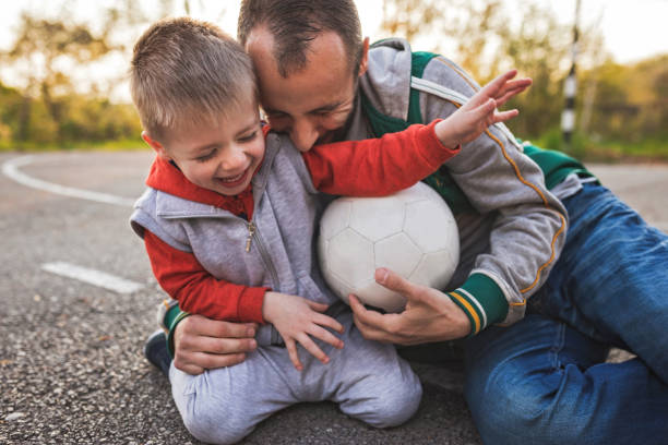 istock Father And Little Son On Soccer Field 1142225212