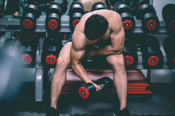 istock Strong Athletic Asian Man workout with dumbbell curl Concentration muscle upper arm for bodybuilding feeling so strong and powerful,Bodybuilder Concept 1142226938
