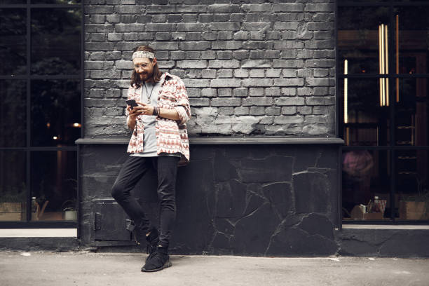 istock Positive male typing in mobile outside 1142229847