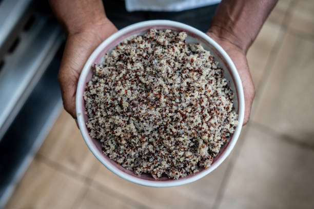 Close-up on a chef holding a plate of quinoa at a restaurant â healthy eating concepts