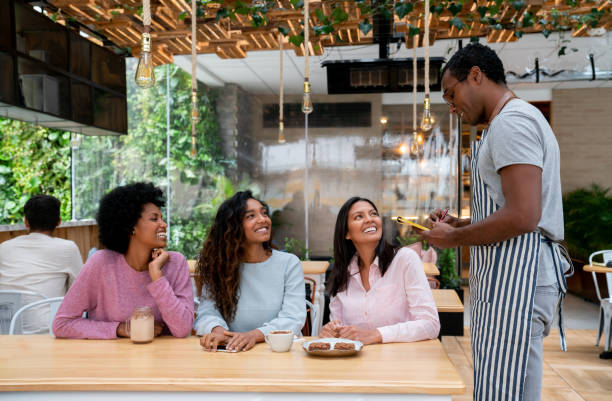 istock Waiter taking order to a group women at a restaurant 1142230309
