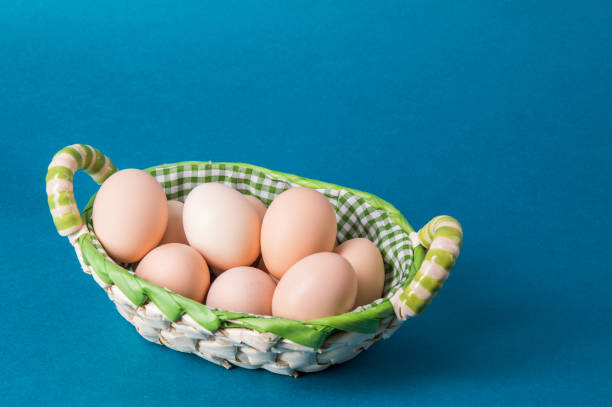 istock Macro. Farm brown eggs in a wicker basket lined with checkered fabric. Copy space. 1142231418