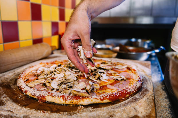 istock Putting Mushrooms On Pizza In Pizza Restaurant 1142231868