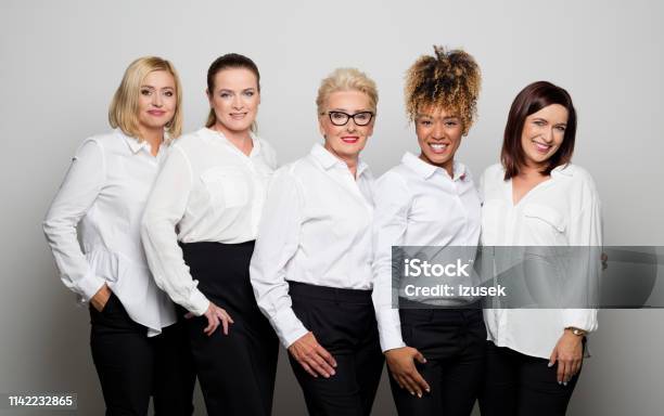 Portrait Of Smiling Female Owners In Studio Stock Photo - Download Image Now - Business, Mature Women, Multiracial Group