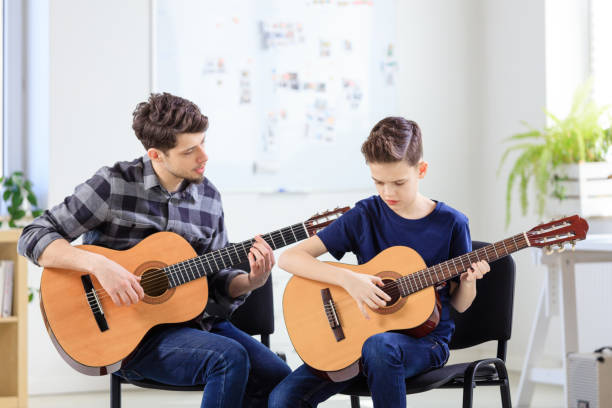 istock Guitar teacher with his student 1142233115