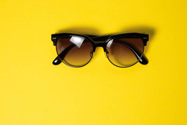 istock Sunglasses lie on a yellow background, close-up 1142234242