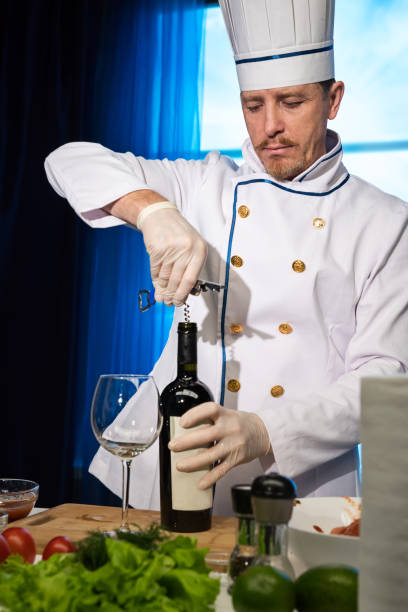 istock Chef opens a bottle of wine 1142234278