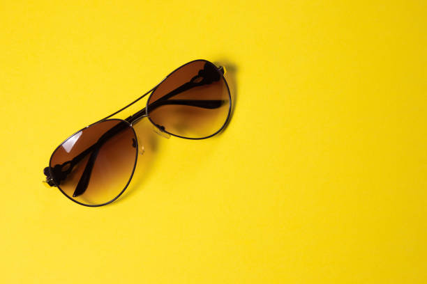 istock Sunglasses lie on a yellow background, close-up 1142234291