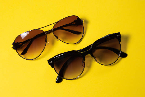 istock Sunglasses lie on a yellow background, close-up 1142235443
