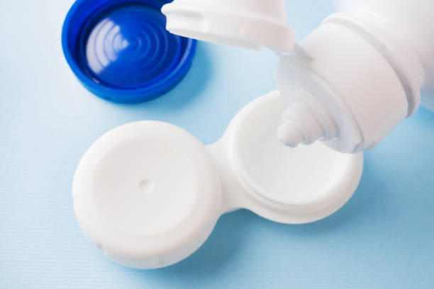 istock Contact lenses, solution bottle and lens storage container. Close up. Selective focus. 1142235713