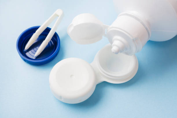 istock Contact lenses, solution bottle and lens storage container. Close up. Selective focus. 1142236800