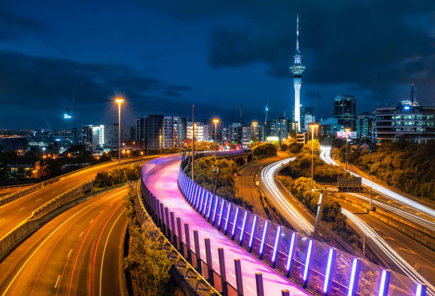 Auckland night perspective Light trails from car traffic on the highways near Auckland's city centre, and the glow from the city's elevated bicycle land and footpath. auckland stock pictures, royalty-free photos & images