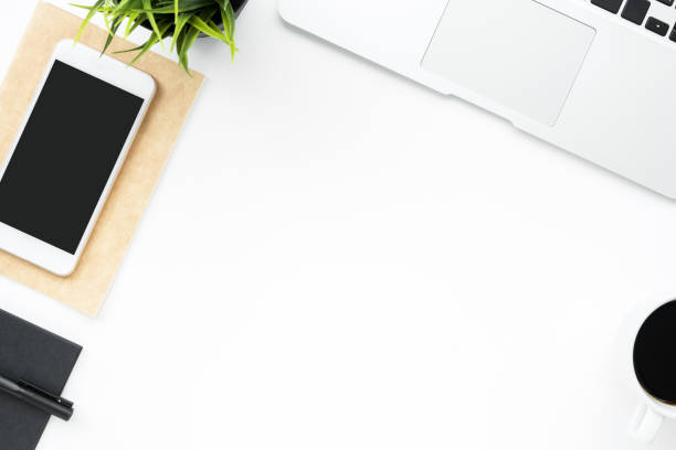 istock White office desk table with smartphone, laptop computer and supplies. Top view with copy space, flat lay. 1142238524