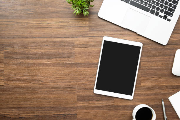 istock Wood office desk table with tablet and supplies. Top view with copy space, flat lay. 1142238546