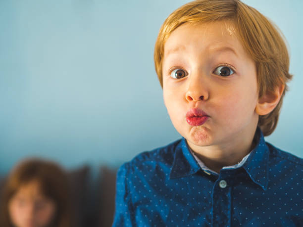 istock Little funny blonde boy on white 1142238600