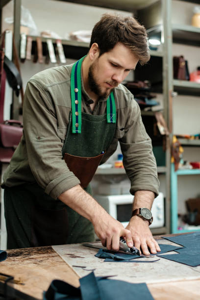 istock A master cuts natural leather for goods in his workshop 1142238659