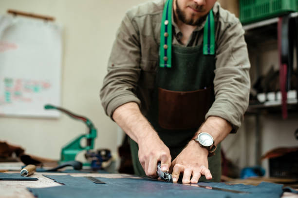 istock A master cuts natural leather for goods in his workshop 1142238660