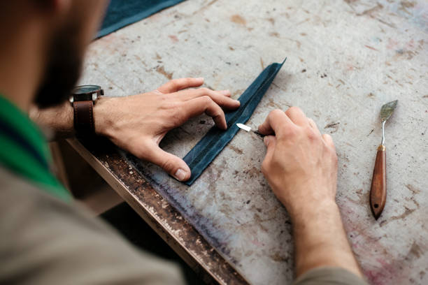 istock A master workes with details for future goods from natural leather 1142238679