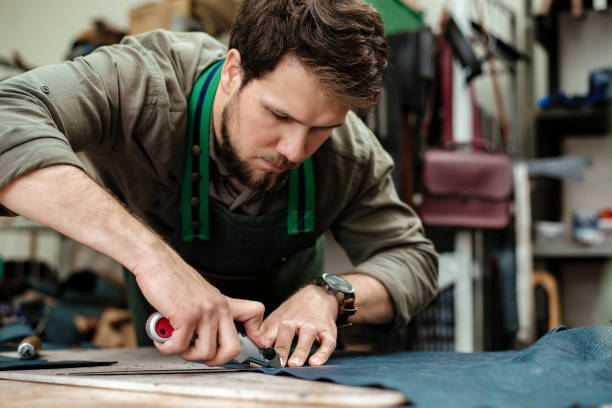istock A master cuts natural leather for goods in his workshop 1142238681