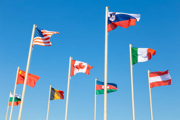 istock Flags of different countries fluttering agains blue sky 1142241682