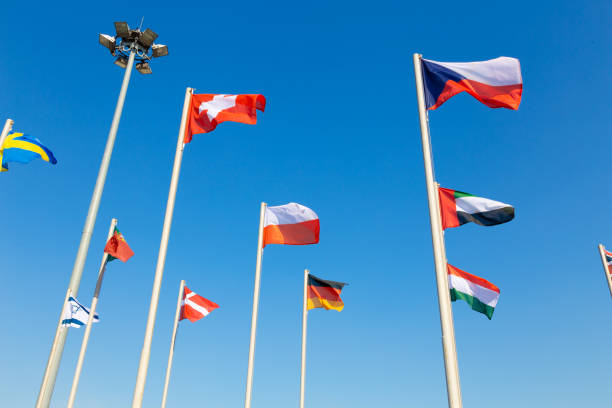 istock Flags of different countries fluttering agains blue sky 1142241686