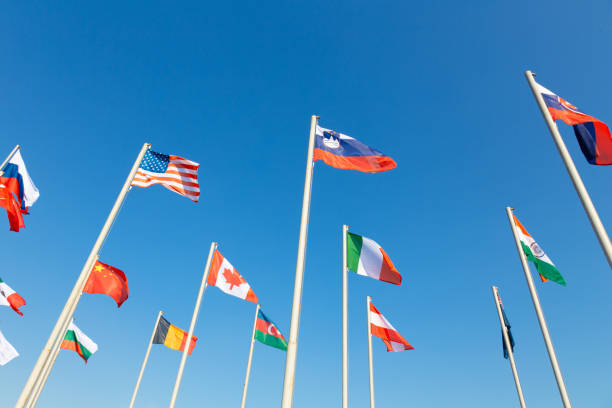 istock Flags of different countries fluttering agains blue sky 1142241697