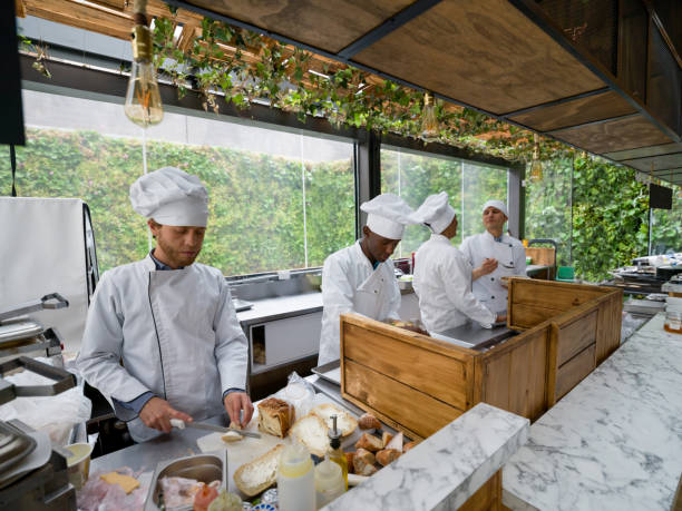 istock Happy group of chefs cooking in a kitchen at a restaurant 1142243785