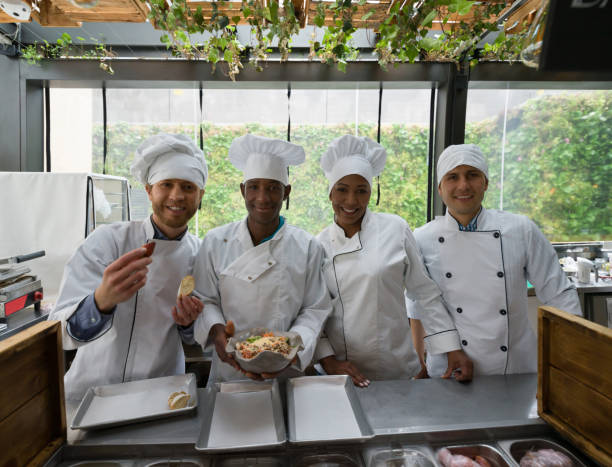 istock Happy group of chefs in a kitchen at a restaurant 1142243791