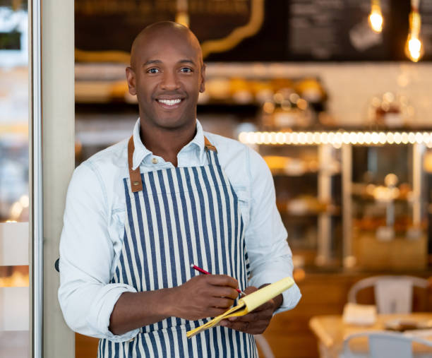 istock Waiter working at a restaurant and looking very happy 1142243889