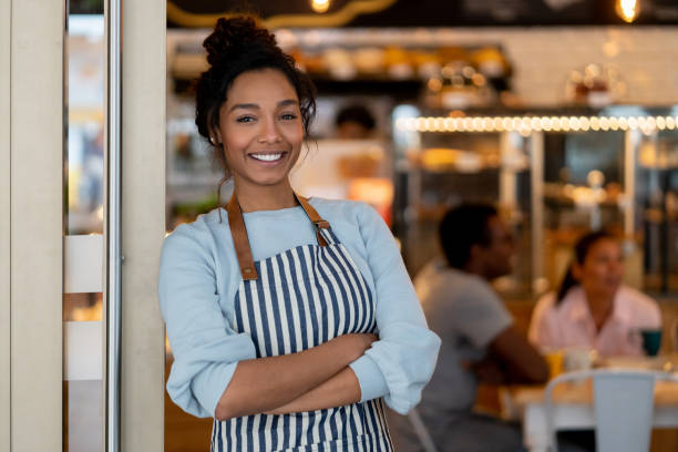 istock Happy African American waitress working at a restaurant 1142243900