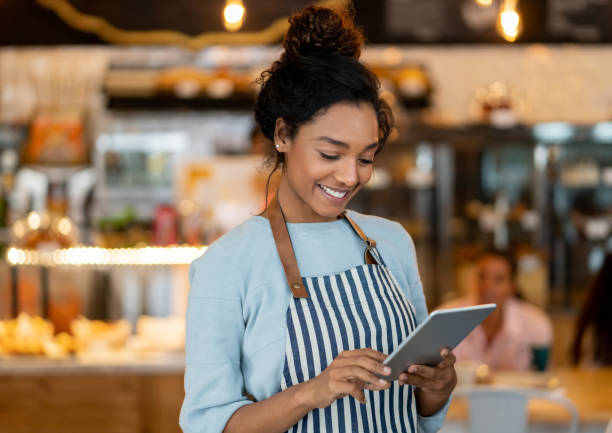 istock Beautiful business owner working at a restaurant using a digital tablet 1142243915
