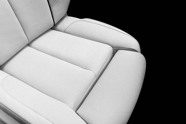 istock White leather interior of a car. Perforated white leather comfortable seats with stitching isolated on black background. Car interior details. Car detailing. Car inside 1142244102