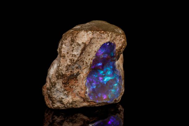 Macro stone Opal mineral in rock on a black background Macro stone Opal mineral in rock on a black background close up opal photos stock pictures, royalty-free photos & images