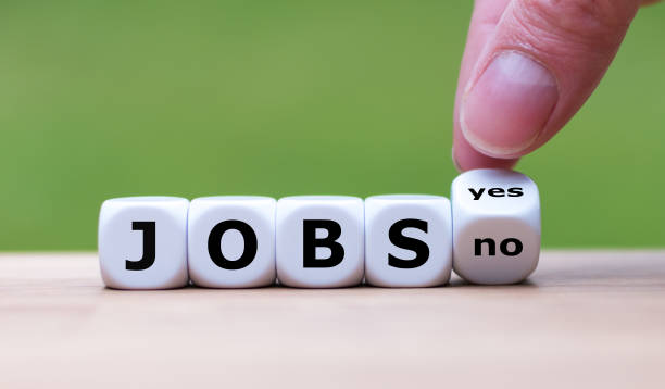 istock Jobs available? Hand turns a dice and changes the word 
