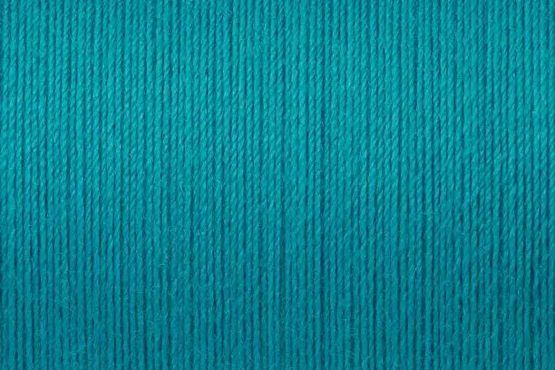Macro picture of green turquoise thread texture surface background
