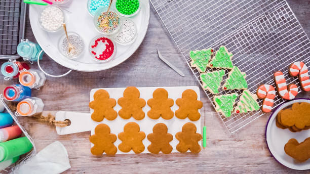 istock Decorating gingerbread and sugar cookies with royal icing for Christmas. 1142248916