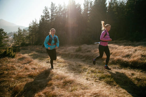 istock Two women running in nature 1142249805