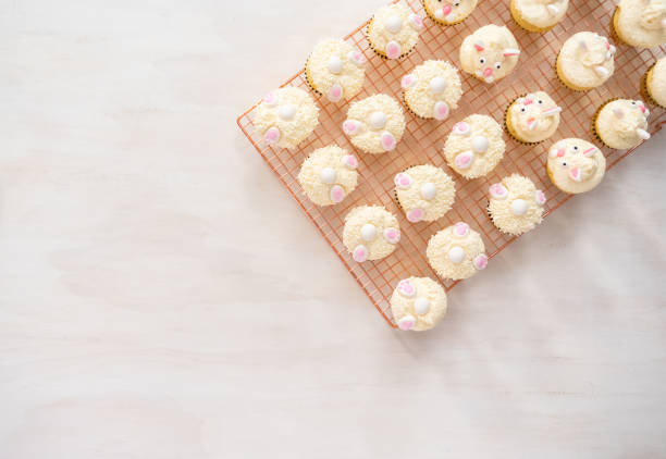 istock Decorating vanilla cupcakes with a white buttercream icing 1142250027