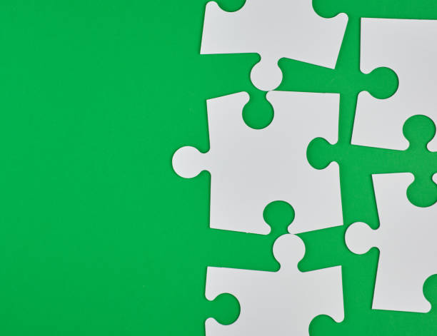 istock blank white big puzzles on green background 1142255949
