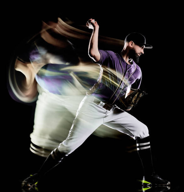 istock baseball player man isolated black background light painting 1142260704