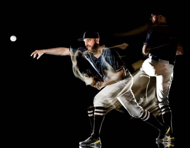 istock baseball player man isolated black background light painting 1142260715