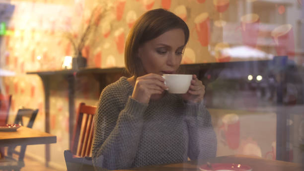 istock Beautiful woman enjoying warm drink, dreaming about future and making plans 1142261401