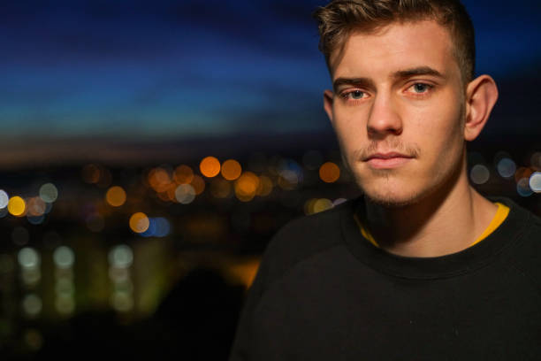 istock Casual young man by city lights 1142262526