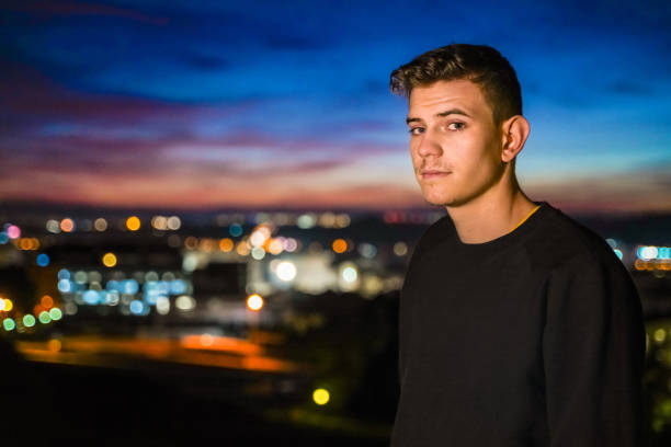 istock Casual young man by city lights 1142262856