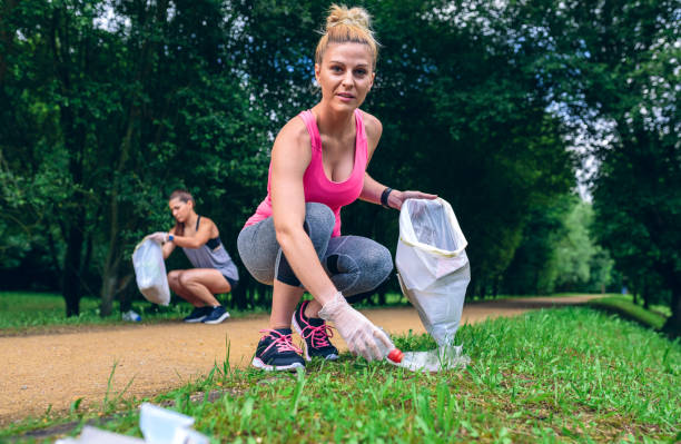 istock Girl picking up trash doing plogging 1142263082