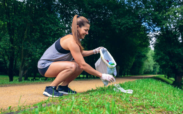 istock Girl with garbage bag doing plogging 1142263083