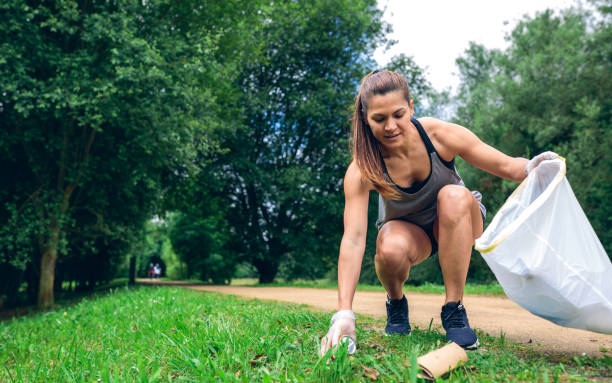 Girl with garbage bag doing plogging stock photo