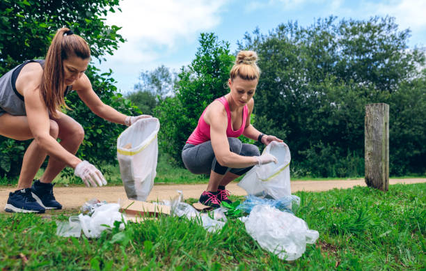 istock Girls with garbage bag doing plogging 1142263101